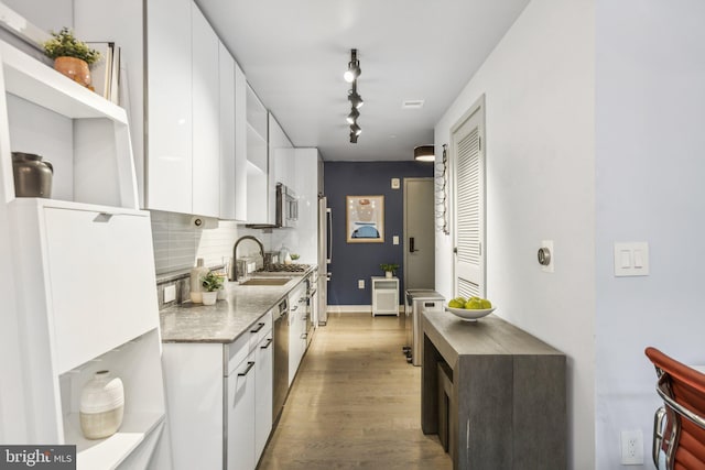 kitchen with stainless steel appliances, white cabinetry, and open shelves