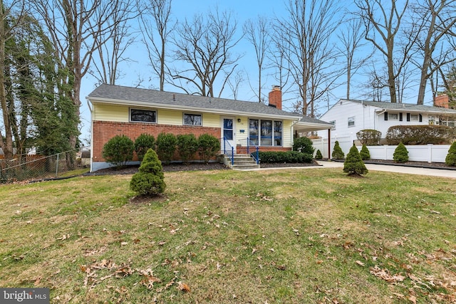 single story home with an attached carport, brick siding, fence, driveway, and a front lawn