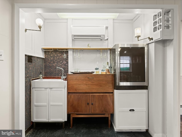 11116 Liberty Rd, Owings Mills, MD 21117 - kitchen with a sink, white cabinets, backsplash, dark tile patterned floors, and a wall mounted air conditioner