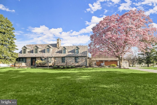 11116 Liberty Rd, Owings Mills, MD 21117 - cape cod home with a front yard, a chimney, stone siding, driveway, and a garage