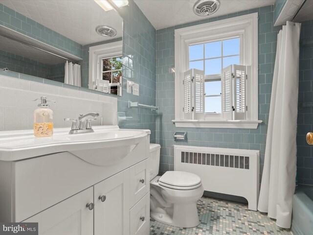 11116 Liberty Rd, Owings Mills, MD 21117 - full bath featuring radiator, tile walls, toilet, tile patterned flooring, and vanity