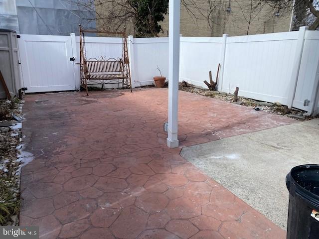 view of patio with a gate and fence