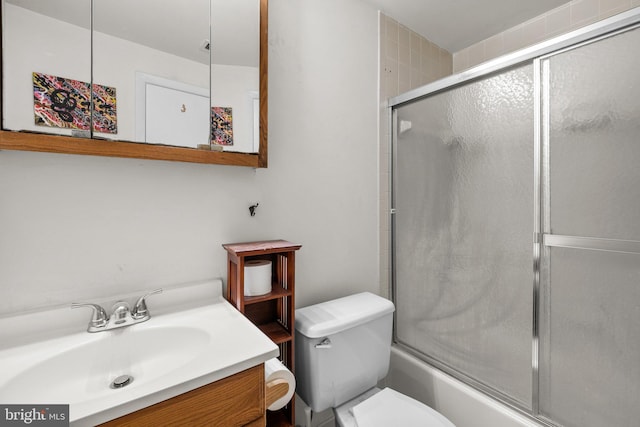 full bath with shower / bath combination with glass door, vanity, and toilet