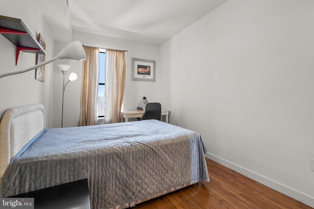 bedroom featuring wood finished floors and baseboards