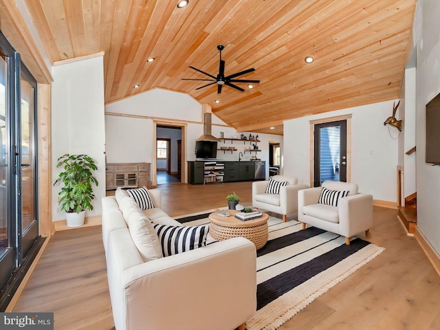 living room featuring vaulted ceiling, light wood finished floors, wood ceiling, and a healthy amount of sunlight