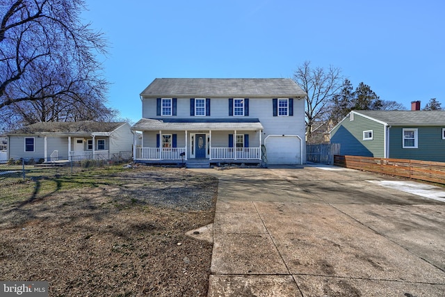 view of front facade with a garage, fence, covered porch, and driveway