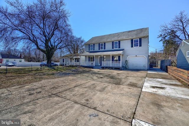 view of front of house with a porch, an attached garage, driveway, and fence