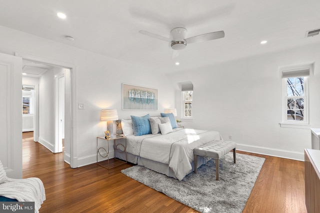 bedroom with baseboards, visible vents, wood finished floors, and recessed lighting