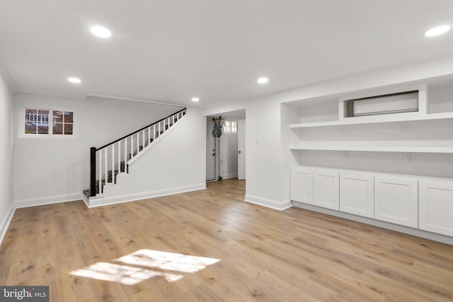 unfurnished living room featuring light wood-style floors, recessed lighting, stairway, and baseboards