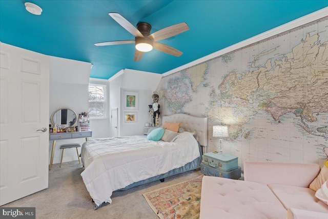 bedroom featuring ceiling fan, ornamental molding, and light colored carpet