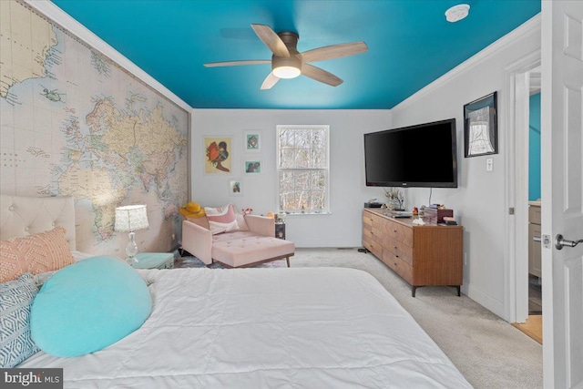 bedroom featuring light carpet, ceiling fan, baseboards, and crown molding