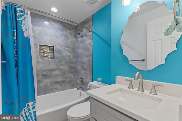 bathroom featuring toilet, vanity, visible vents, and shower / tub combo with curtain