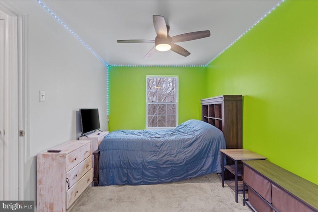 bedroom featuring a ceiling fan and light colored carpet