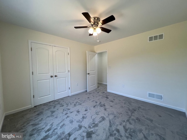 unfurnished bedroom with a closet, carpet, visible vents, and baseboards