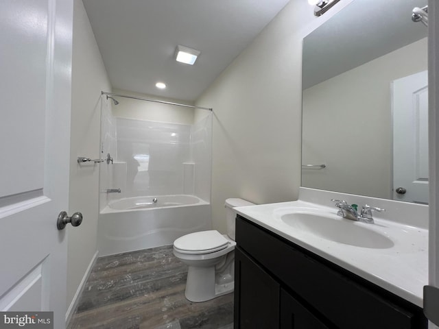 bathroom with wood finished floors, vanity, toilet, and shower / bathtub combination