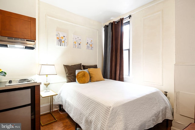 bedroom featuring dark wood-style flooring