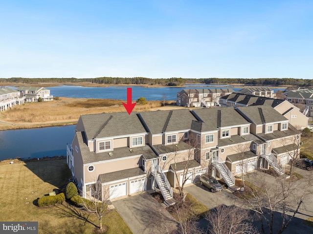 aerial view featuring a residential view and a water view