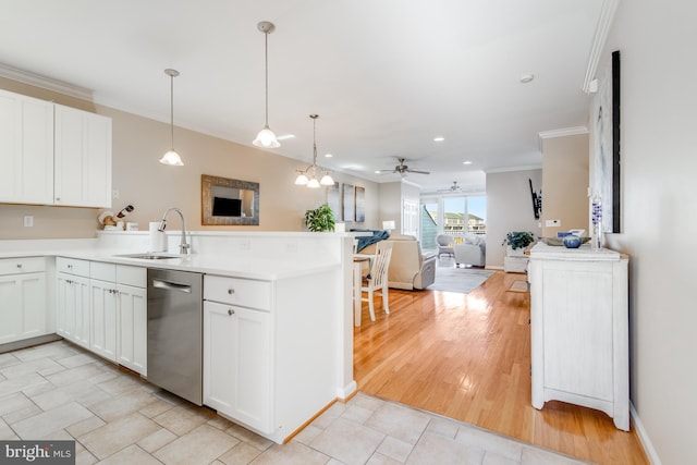 kitchen with stainless steel dishwasher, ornamental molding, open floor plan, a sink, and a peninsula