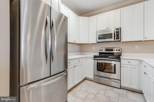 kitchen with light countertops, appliances with stainless steel finishes, and white cabinetry