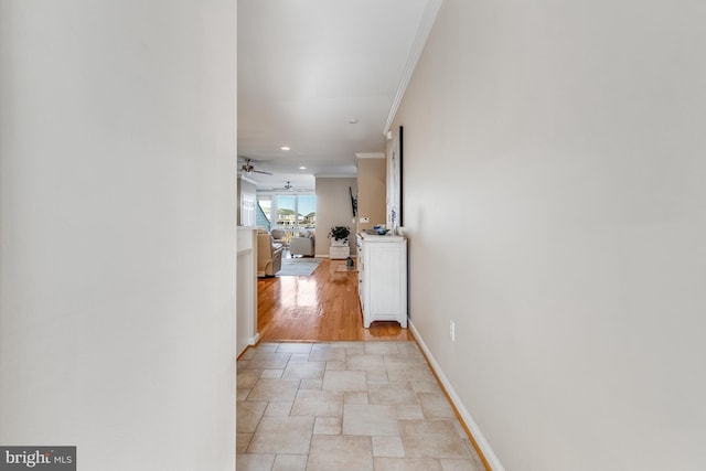 hall with baseboards, ornamental molding, and recessed lighting