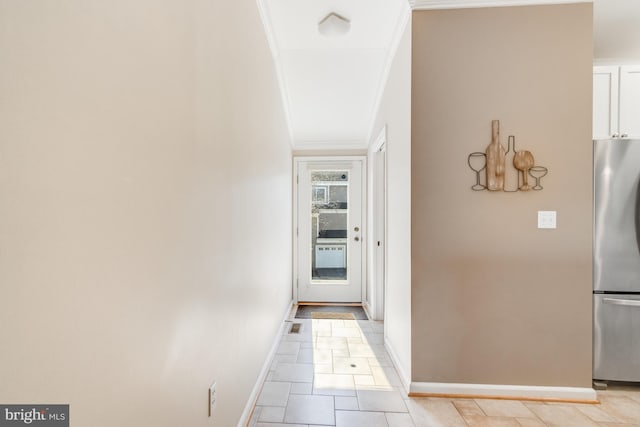 hallway with crown molding and baseboards