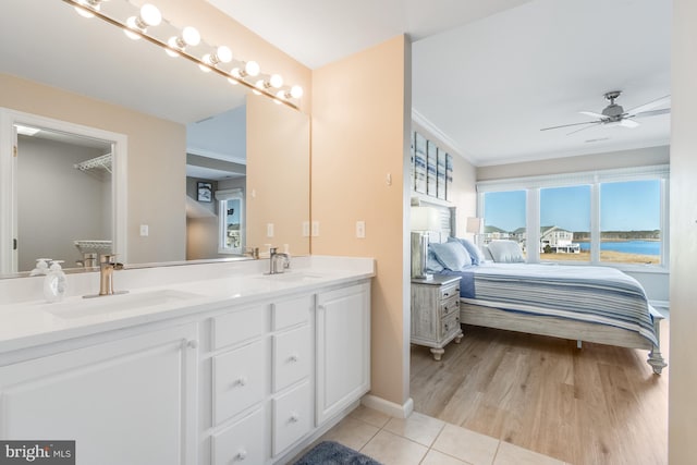 ensuite bathroom featuring double vanity, ensuite bath, a sink, and tile patterned floors