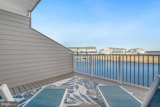 deck featuring a water view and a residential view