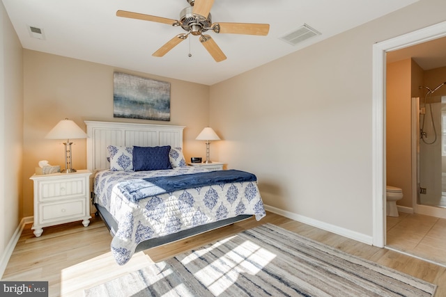 bedroom featuring baseboards, visible vents, and wood finished floors