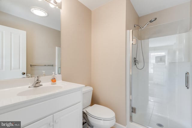 full bath with a stall shower, vanity, and toilet