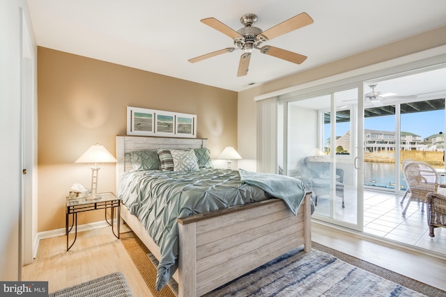 bedroom with baseboards, wood finished floors, a ceiling fan, and access to exterior