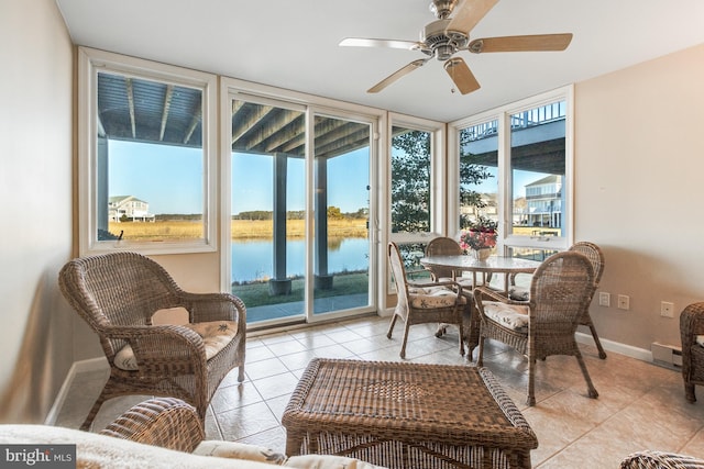 sunroom / solarium with a ceiling fan, a water view, and plenty of natural light