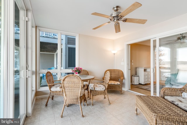 sunroom featuring ceiling fan