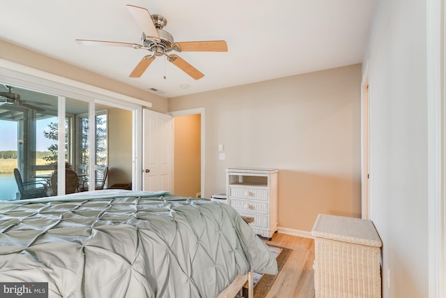 bedroom featuring baseboards, ceiling fan, visible vents, and light wood-style floors