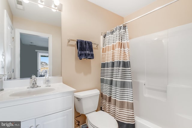 bathroom featuring toilet, shower / tub combo, vanity, and visible vents