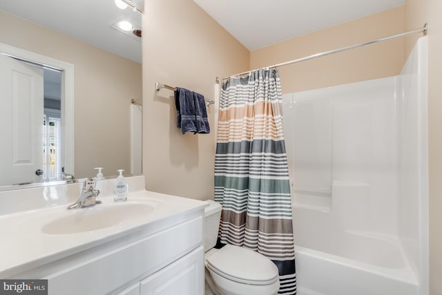 bathroom featuring shower / bath combination with curtain, vanity, and toilet