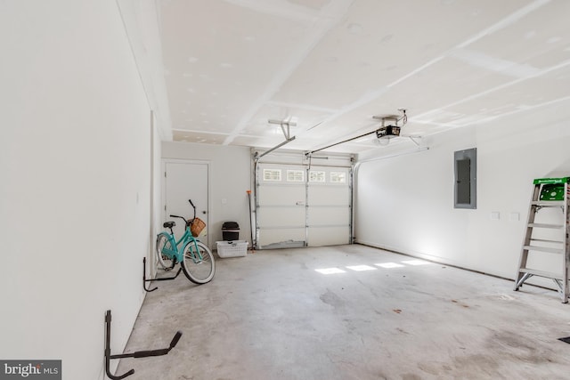 garage with a garage door opener and electric panel