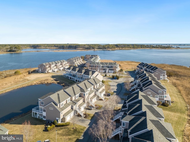 birds eye view of property featuring a water view and a residential view