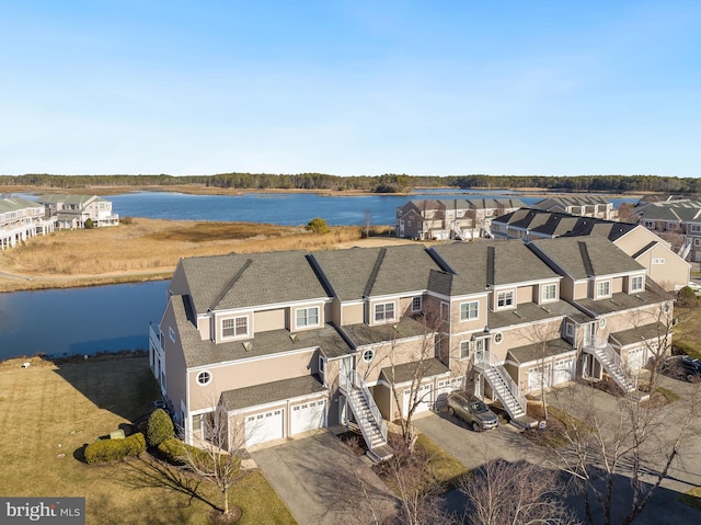 birds eye view of property with a water view and a residential view