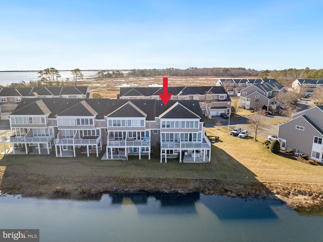 birds eye view of property with a water view and a residential view