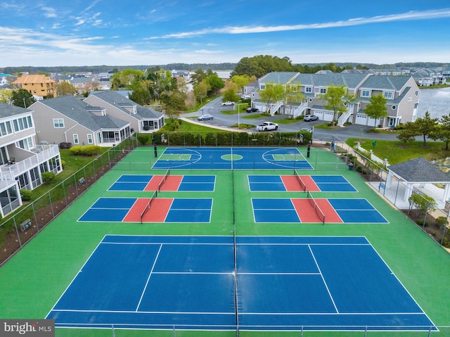 view of sport court featuring a residential view and fence