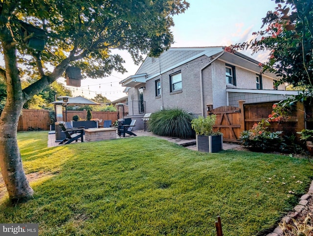 exterior space featuring an outdoor fire pit and fence