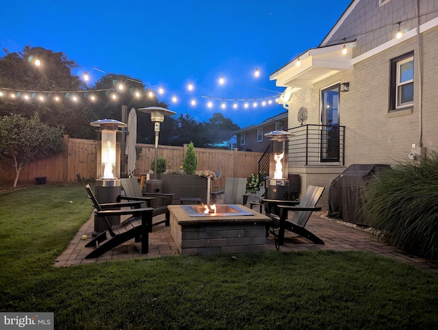 exterior space with an outdoor fire pit, a patio area, and fence