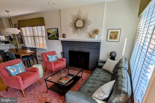 living area with plenty of natural light, a fireplace, and visible vents