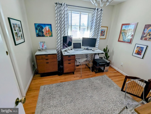 office area with light wood finished floors and baseboards