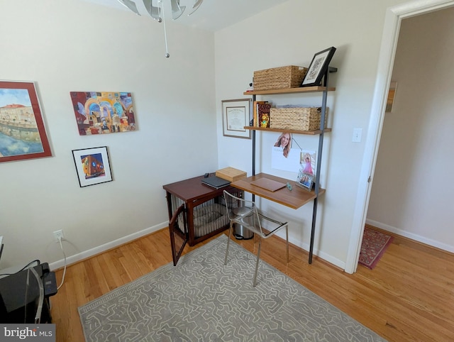 office area featuring baseboards and wood finished floors