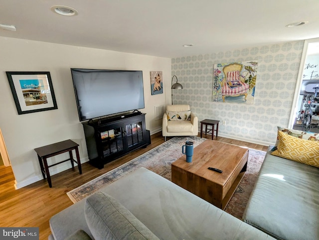 living area with recessed lighting, wood finished floors, and baseboards