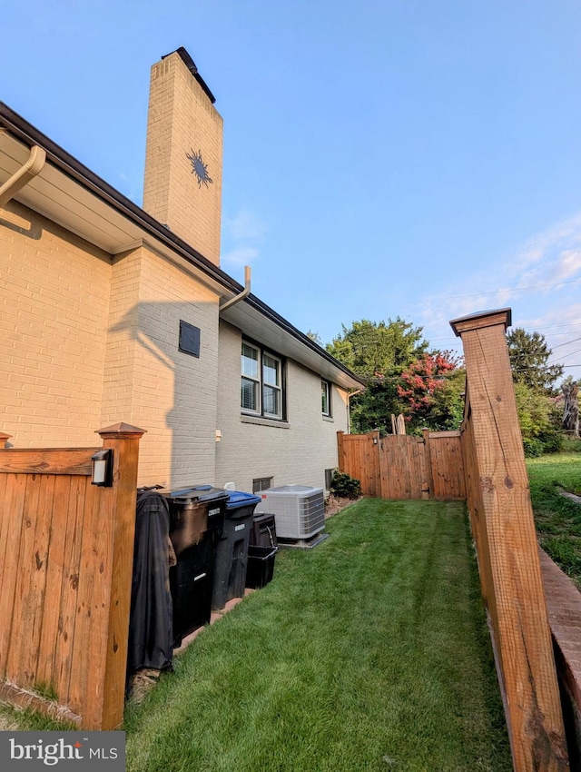 view of yard featuring cooling unit and fence