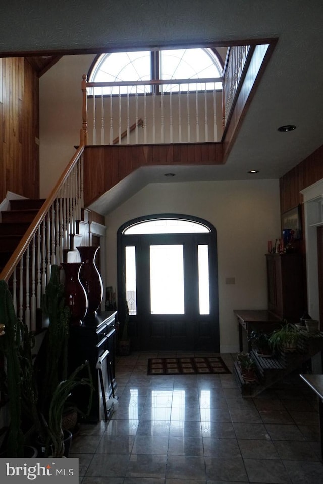 entryway with a towering ceiling and stairs