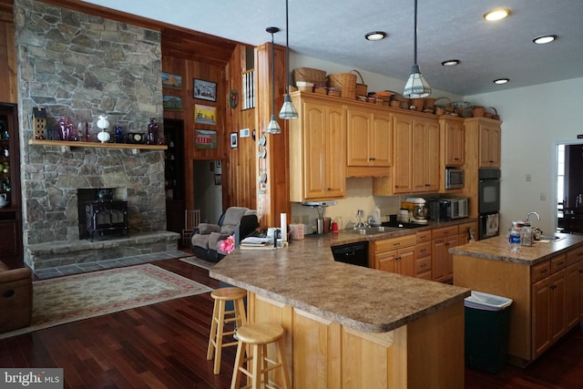 kitchen with open floor plan, decorative light fixtures, dark wood finished floors, and a peninsula