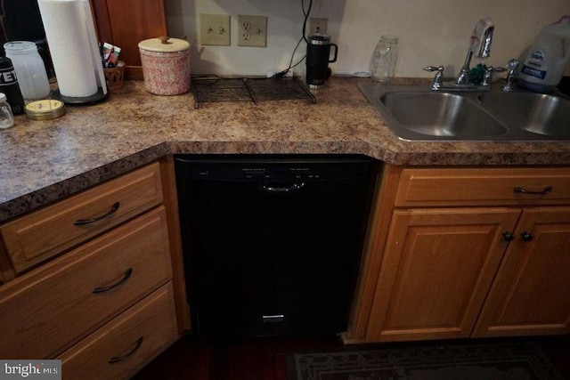 kitchen with black dishwasher, brown cabinets, and a sink